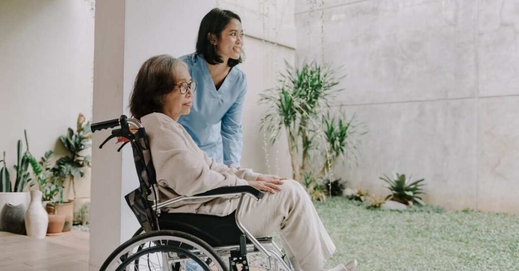 Caregiver helping an elderly woman in a wheelchair enjoy outdoor time at home in Ohio, showing compassionate medical and non-medical home care support