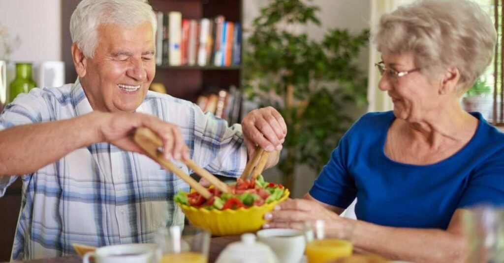 Senior couple preparing a healthy meal at home, showing nutrition and wellness tips that support senior health and independent living with home care assistance.