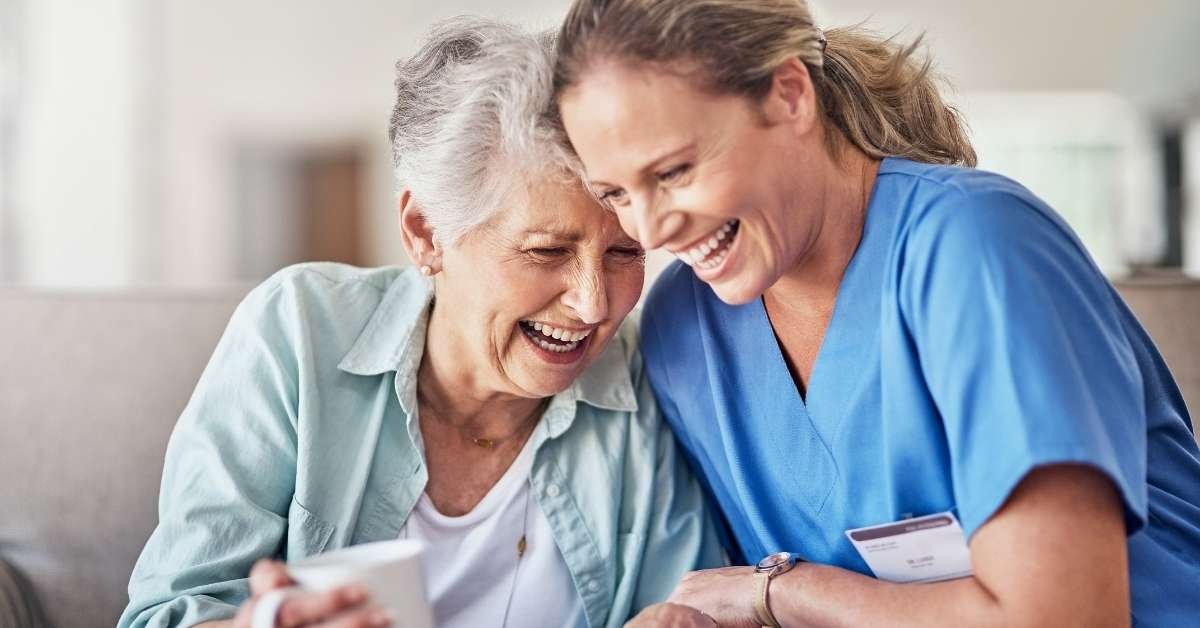 Paid family caregiver supporting an elderly woman at home, showing key considerations for paid family caregivers in Ohio home care programs.